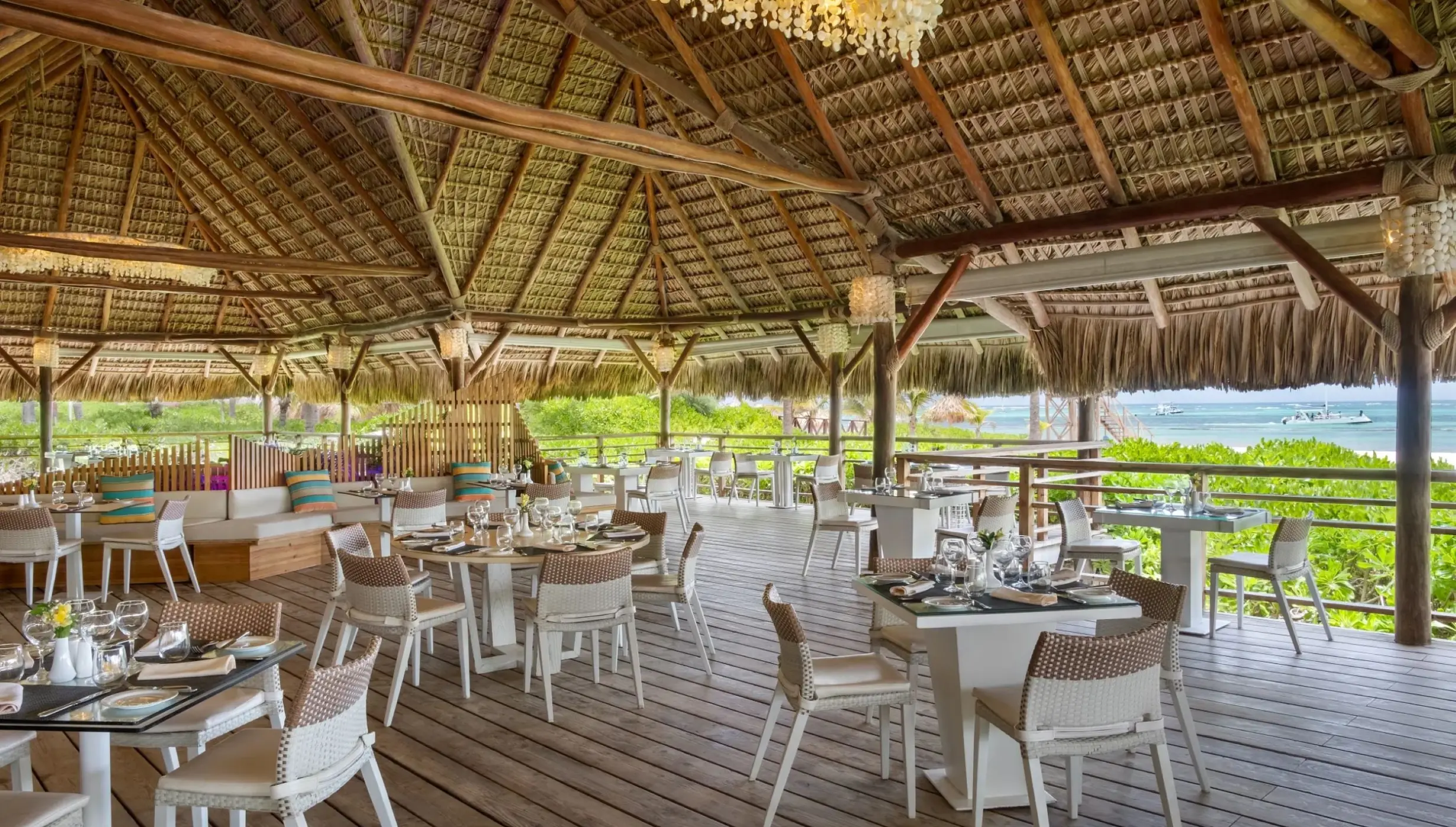 Seaside Grill open-air restaurant with thatched roof at Dreams Royal Beach, Punta Cana