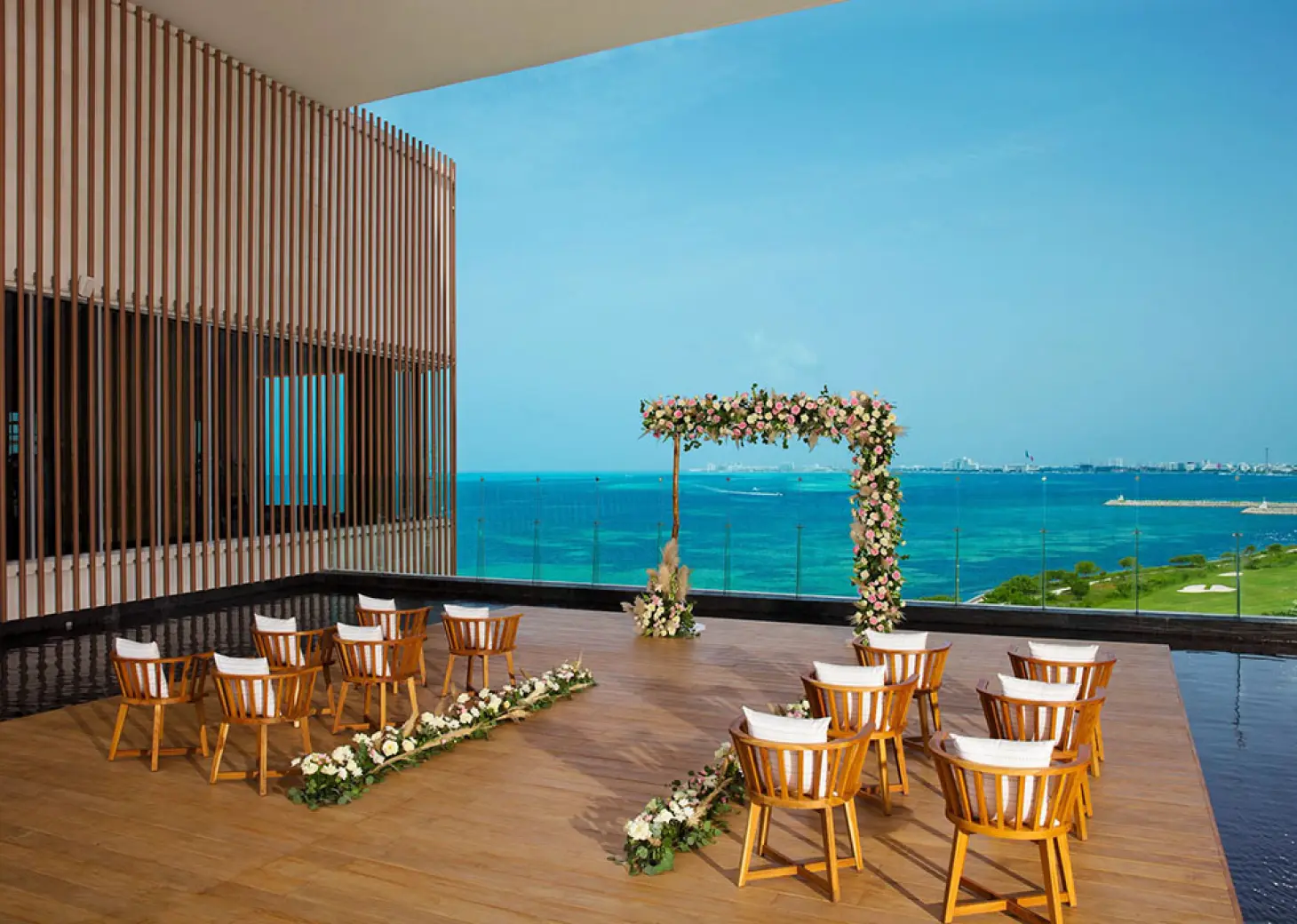 Terrace wedding venue overlooking ocean and golf at Dreams Vista Cancun Golf and Spa