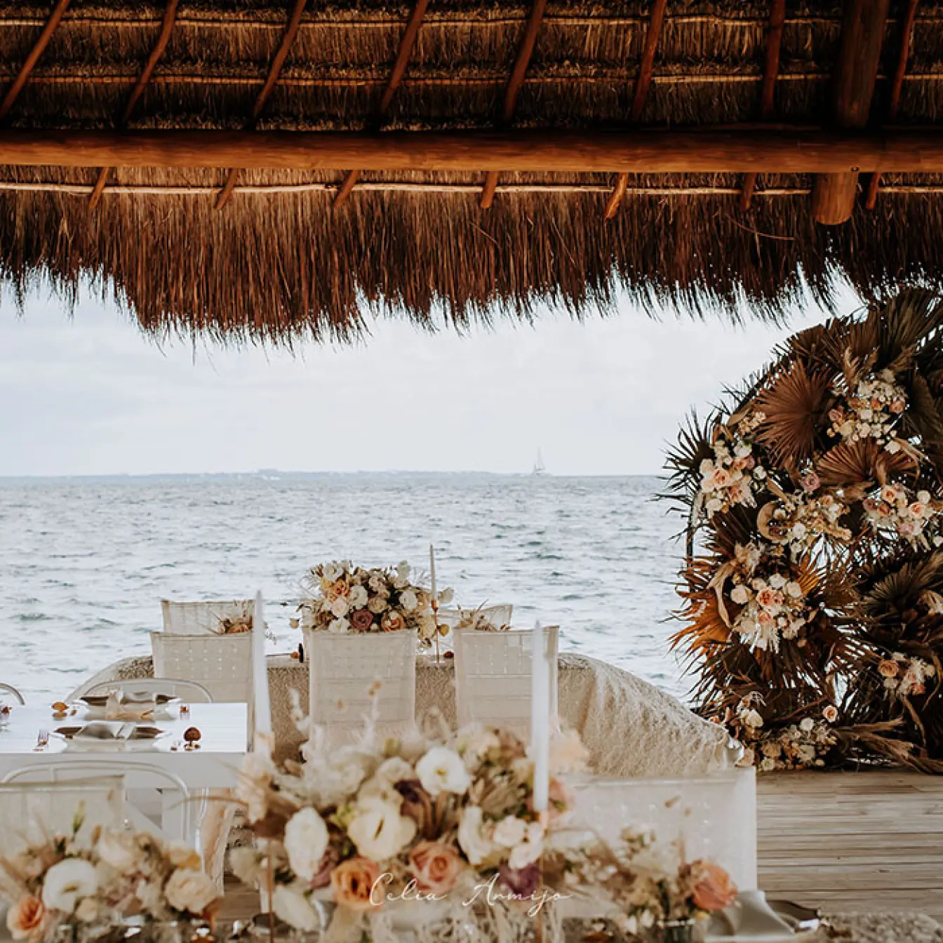 Oceanfront wedding reception under a palapa at Dreams Vista, Cancun