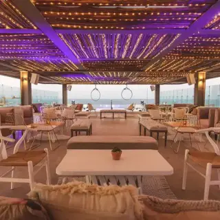 Rooftop lounge with purple lighting and ocean views at Dreams Vista, Cancun