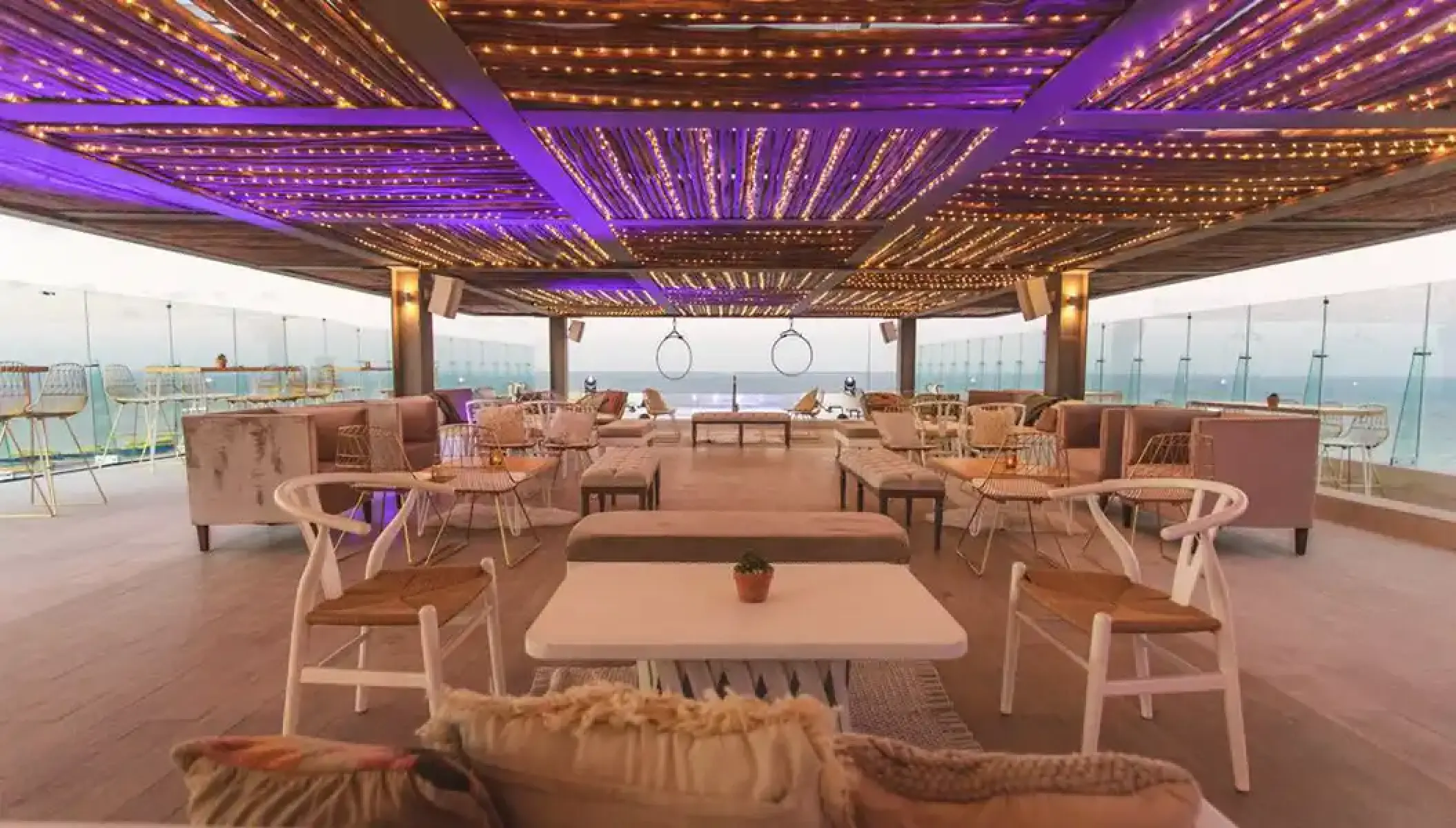 Rooftop lounge with purple lighting and ocean views at Dreams Vista, Cancun
