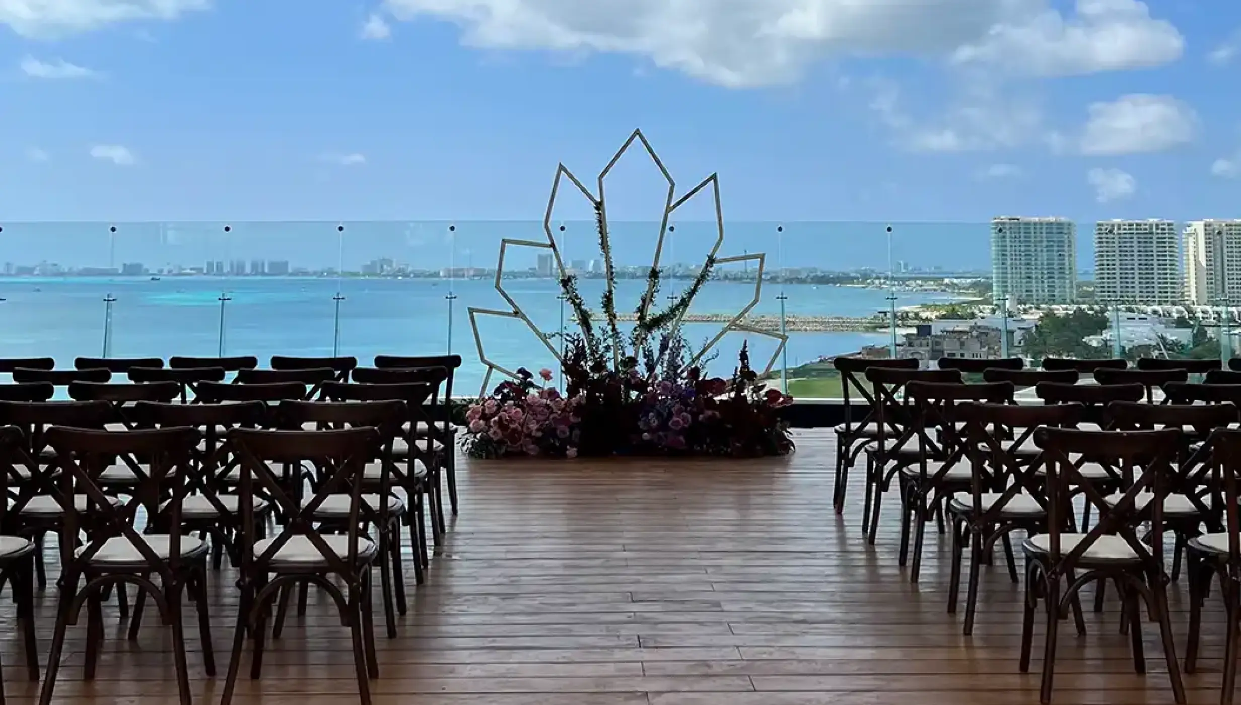 Terrace wedding venue overlooking ocean and golf atDreams Vista Cancun Golf and Spa