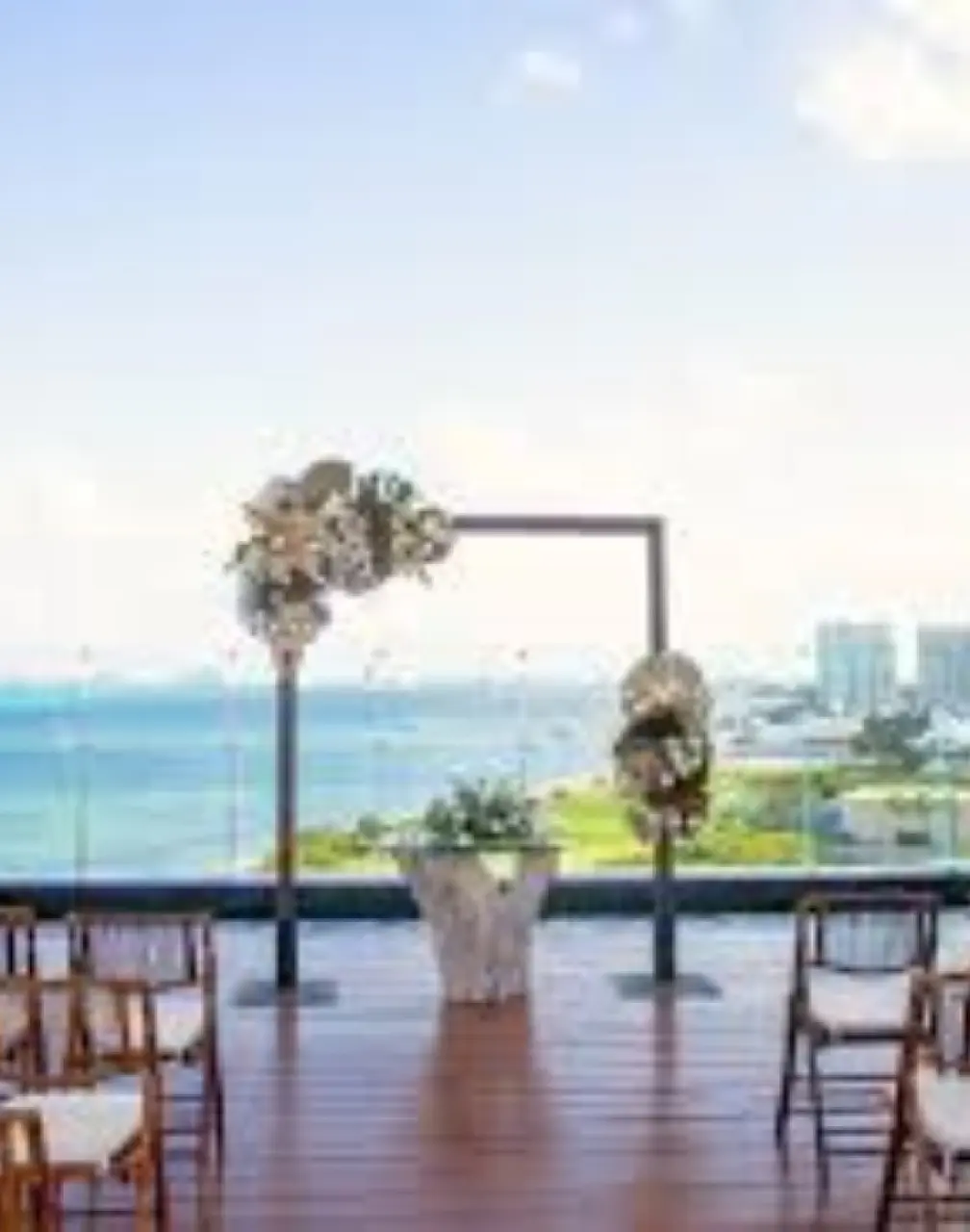 Rooftop wedding ceremony setup with floral arch at Dreams Vista Cancun