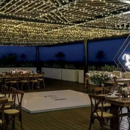 Terrace wedding reception with fairy lights and a dance floor at Grand Palladium Costa Mujeres, Cancun