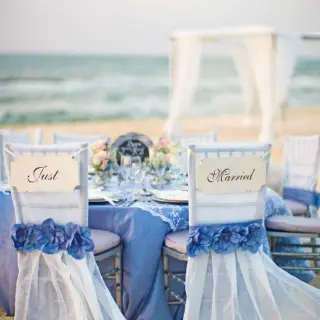 Beachfront wedding reception table with Just Married signs at El Dorado Palafitos, Riviera Maya