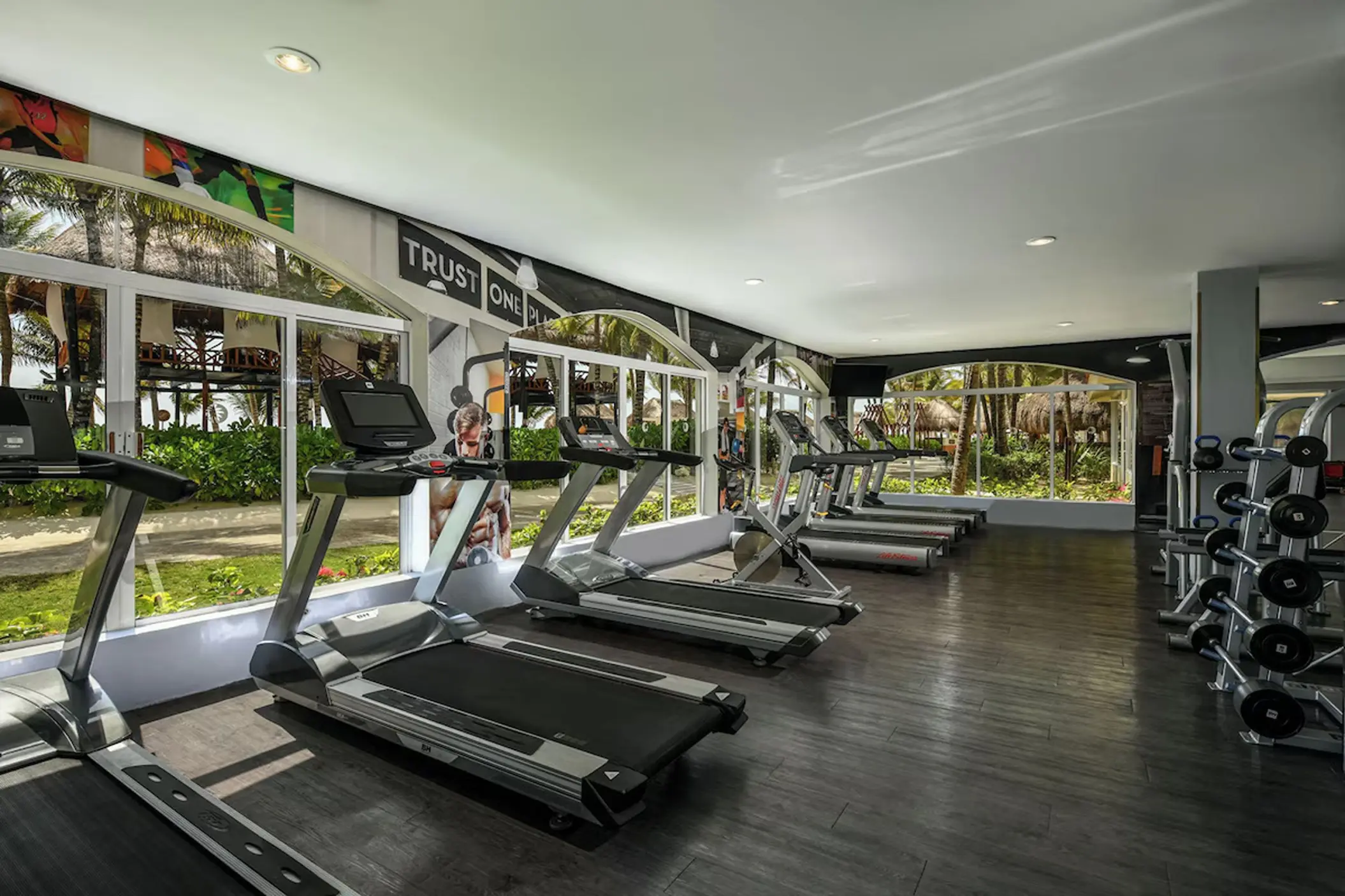 Fitness center with treadmills and weight racks at El Dorado Royale, Riviera Maya