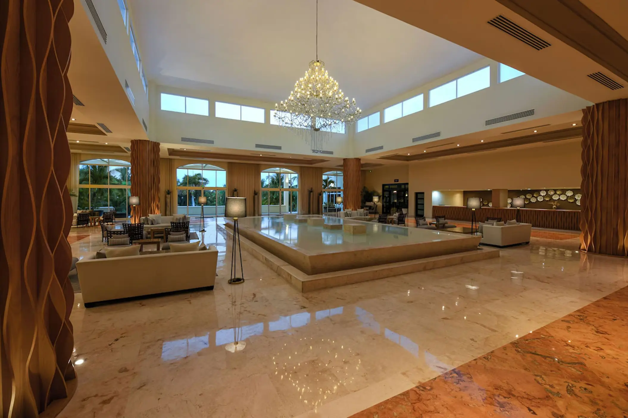 Grand lobby with chandelier and central water feature at El Dorado Royale, Riviera Maya
