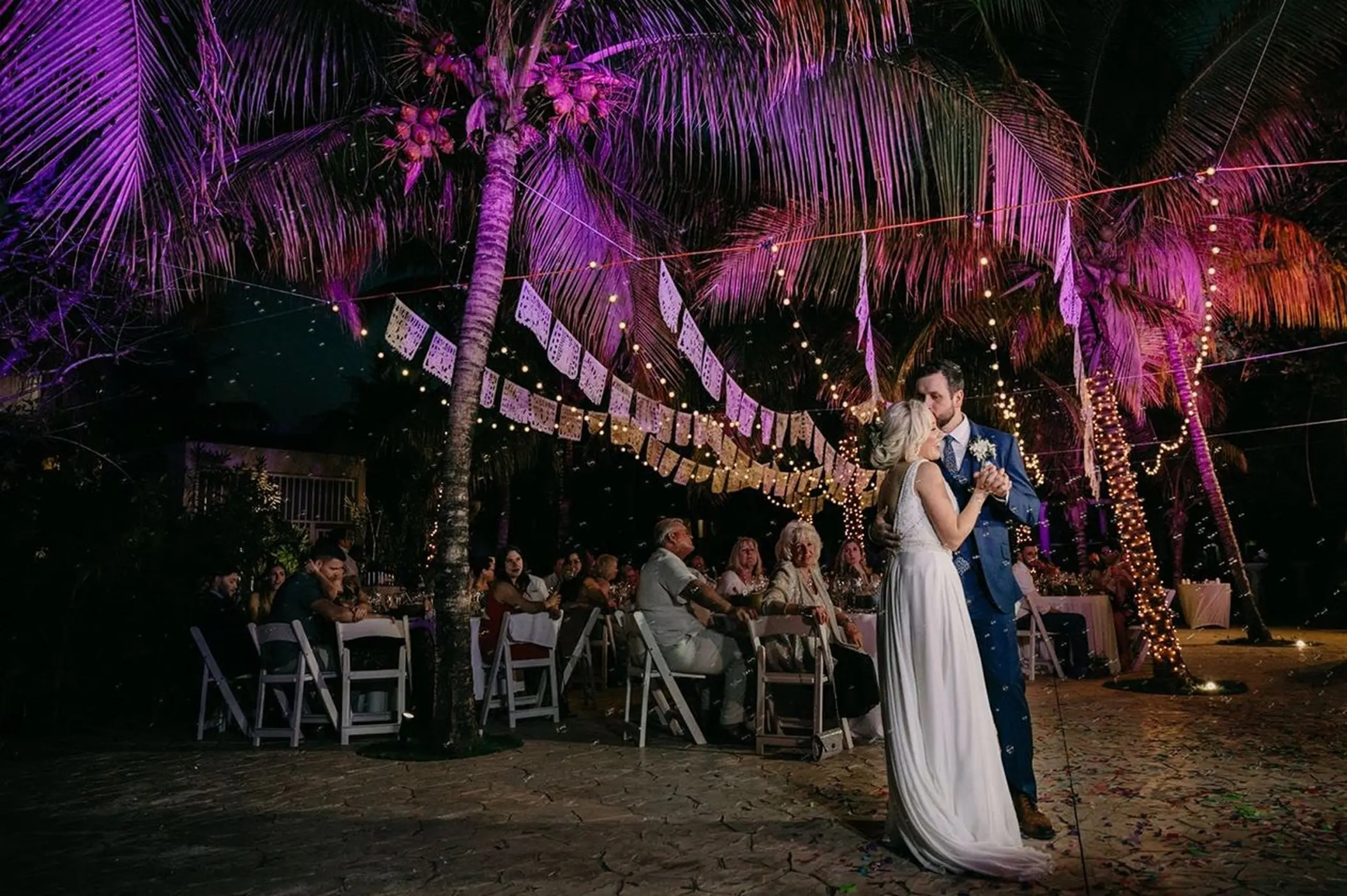 The bride and groom's first dance during an outdoor wedding reception at El Dorado Royale, Riviera Maya