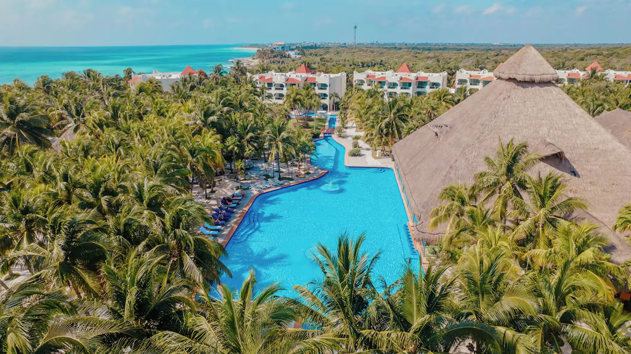Aerial view of the swimming pool and palm trees at El Dorado Royale, Riviera Maya