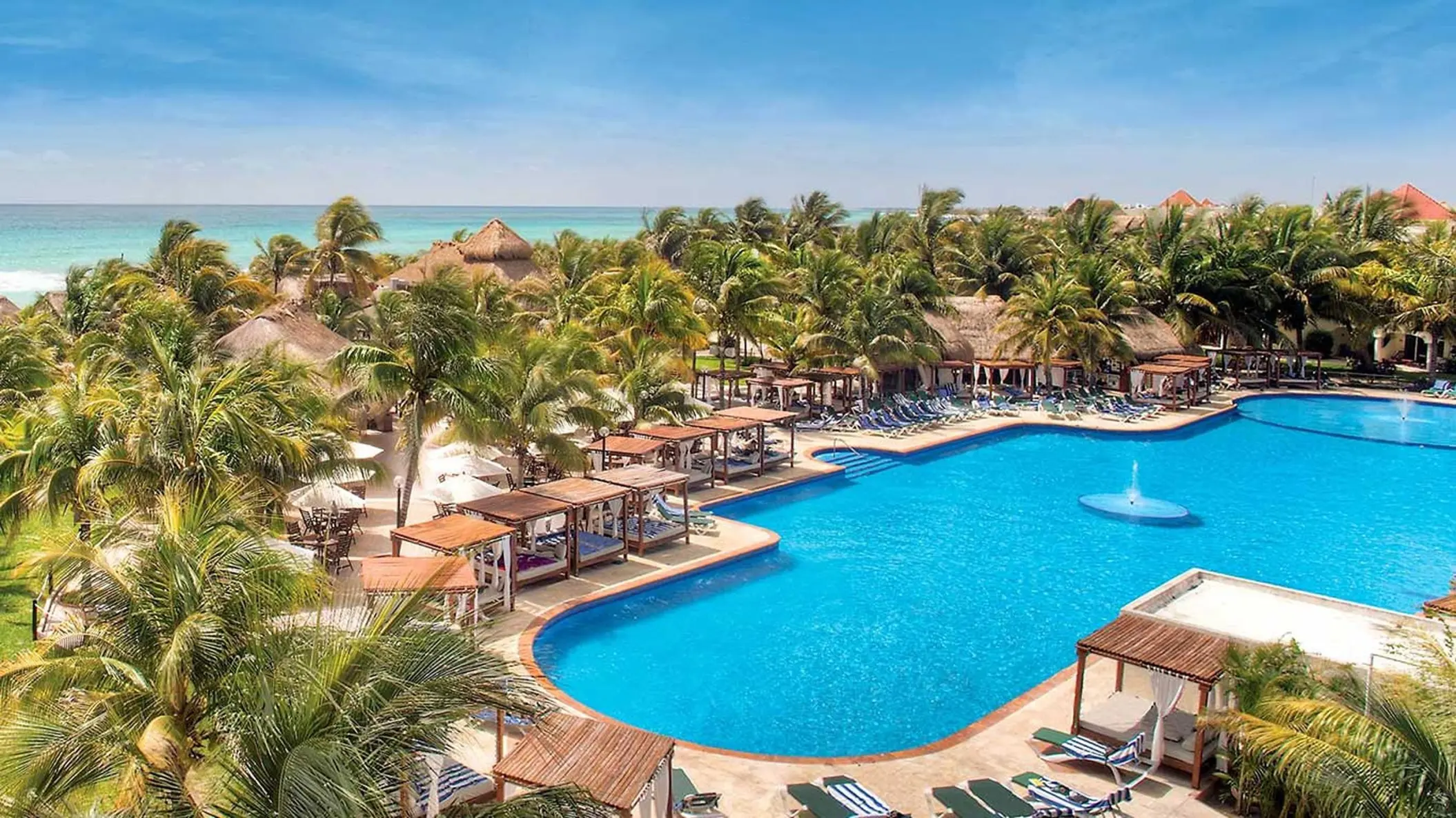El Dorado Royale swimming pool surrounded by palm trees and cabanas, Riviera Maya