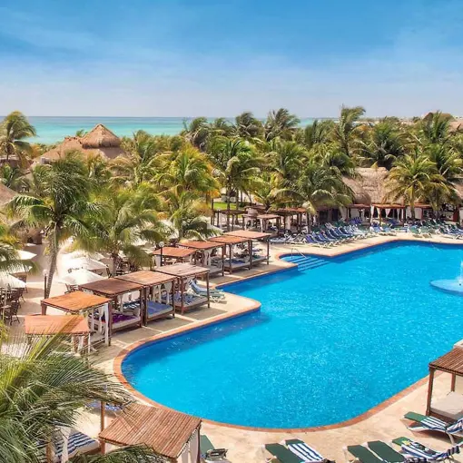 El Dorado Royale swimming pool surrounded by palm trees and cabanas, Riviera Maya