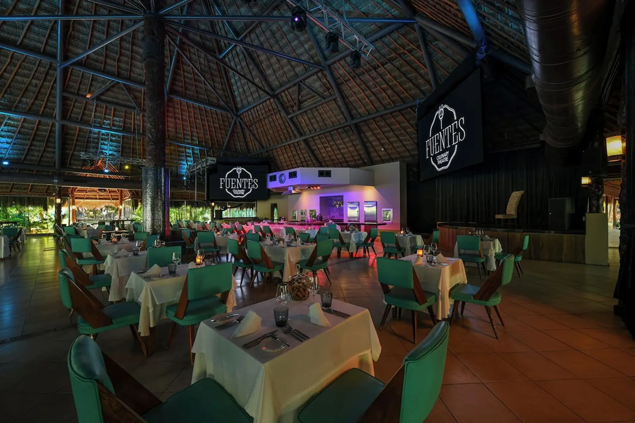 Fuentes Culinary Theatre dining room under a palapa roof at El Dorado Royale, Riviera Maya