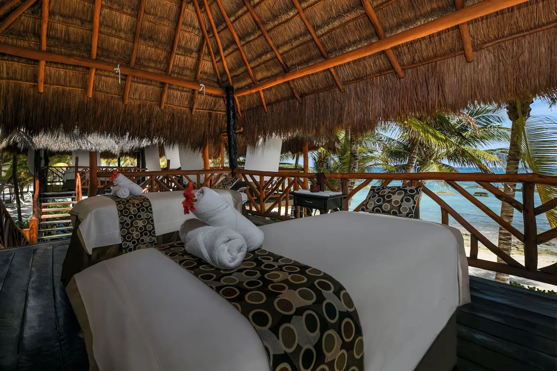 Couples massage beds in an open-air palapa at El Dorado Royale, Riviera Maya