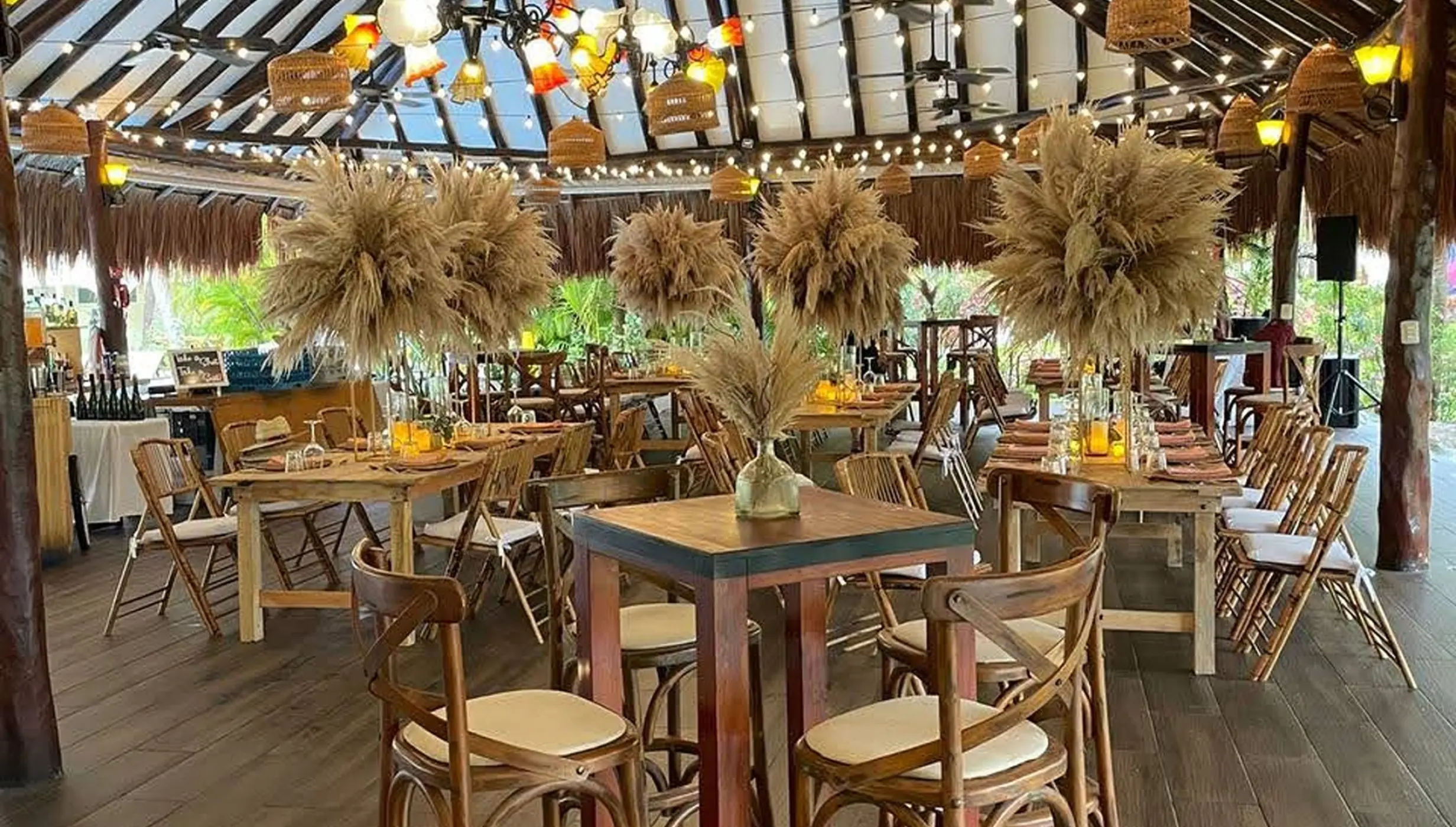 Tucanes bar wedding reception with pampas grass centerpieces at El Dorado Royale, Riviera Maya