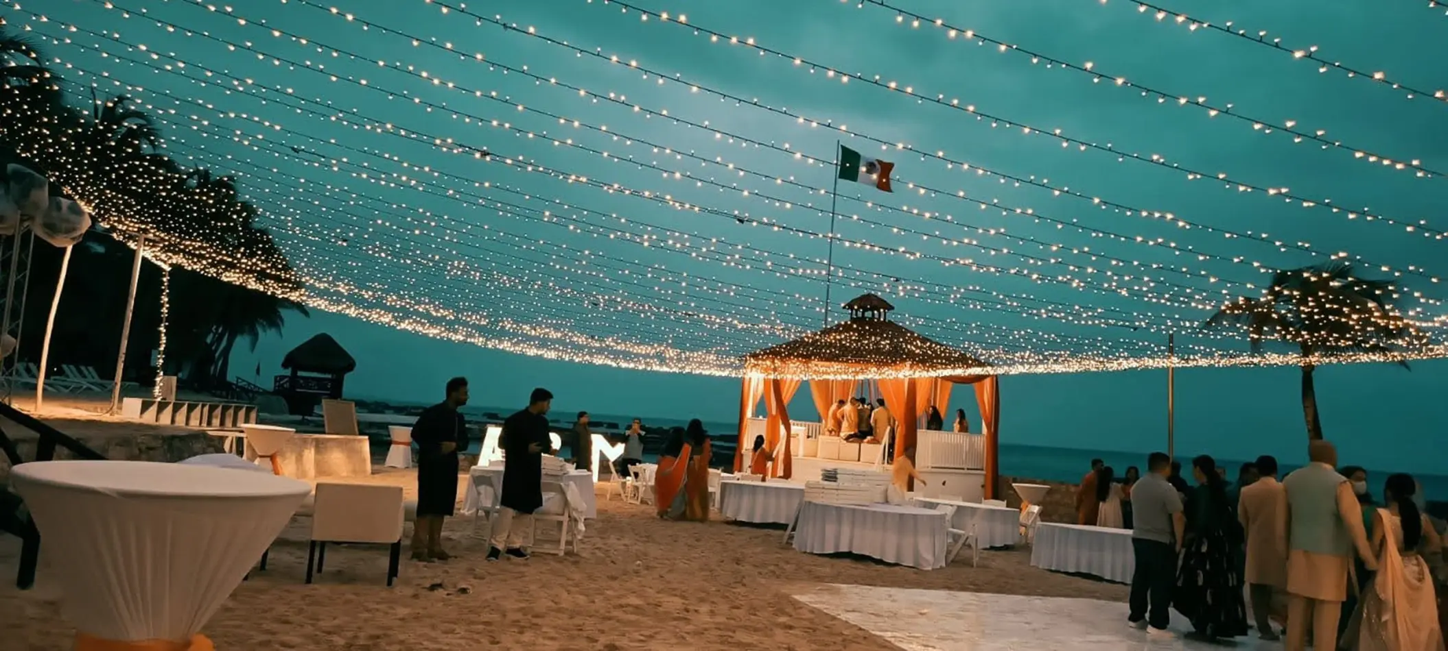 Beachfront wedding reception under string lights at El Dorado Royale, Riviera Maya