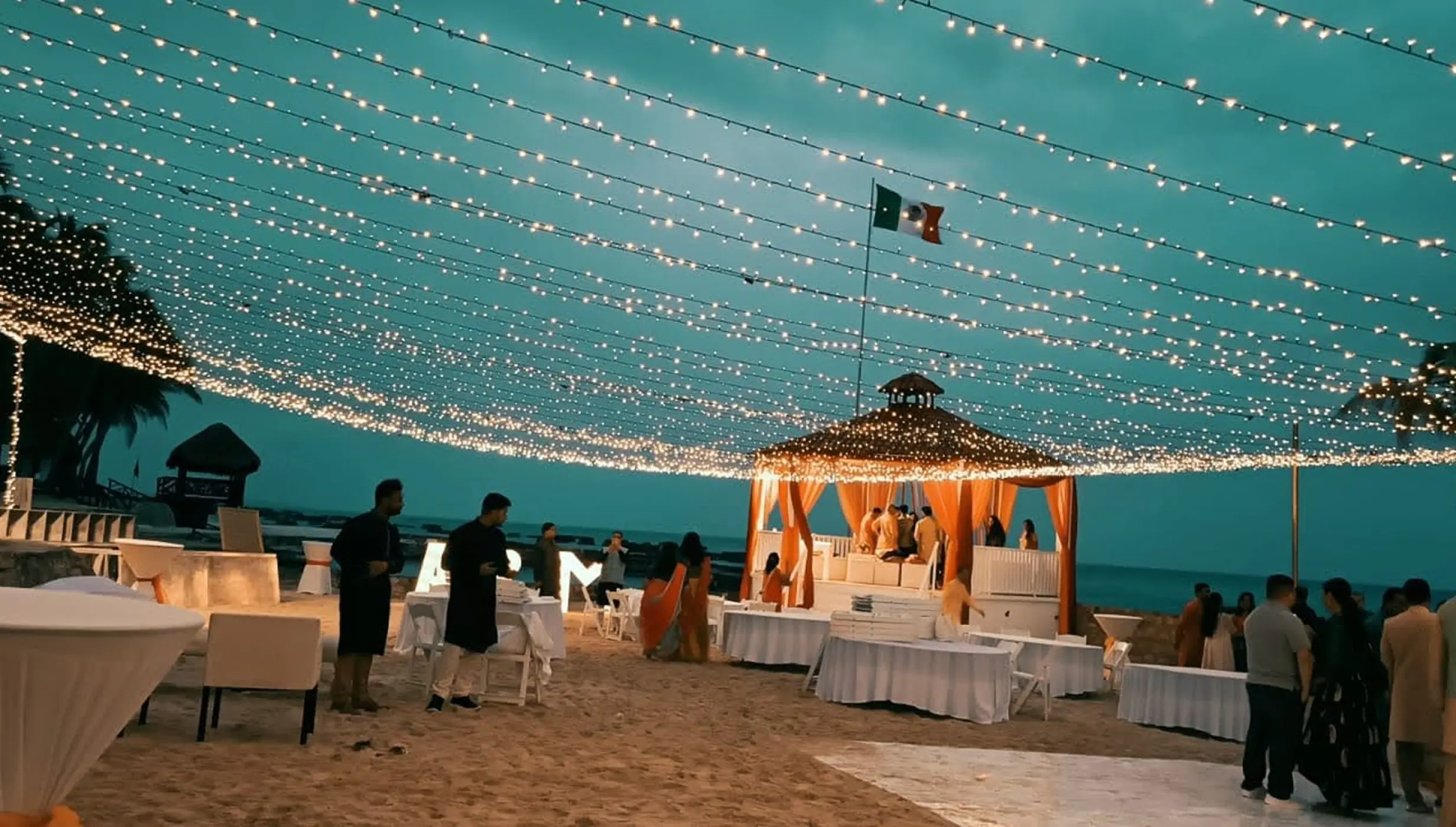 Beachfront wedding reception under string lights at El Dorado Royale, Riviera Maya