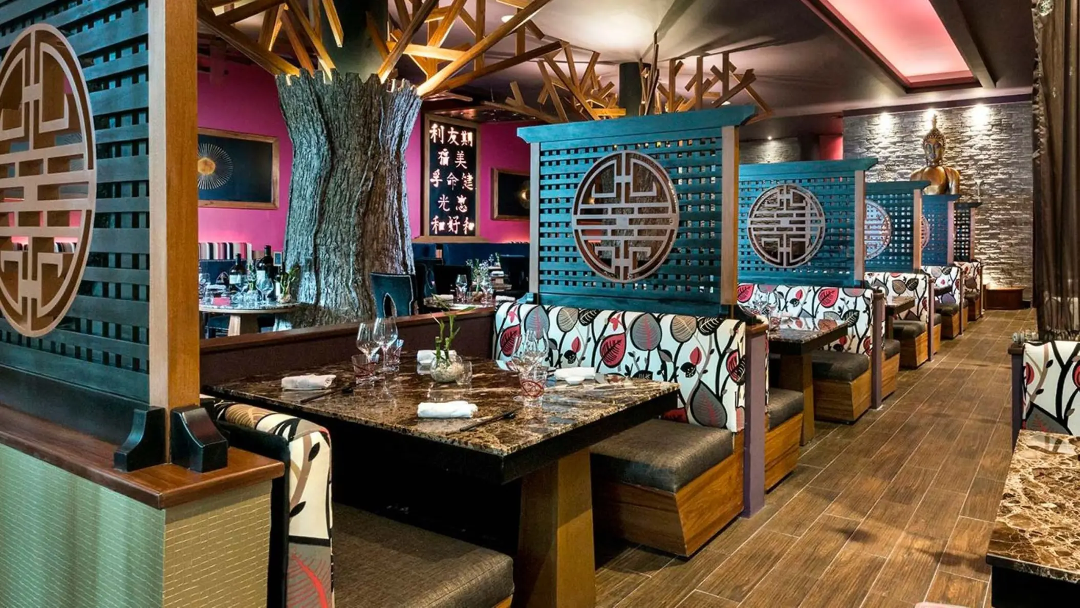 Asian-inspired restaurant dining booths with decorative screens at El Dorado Seaside Palms, Riviera Maya