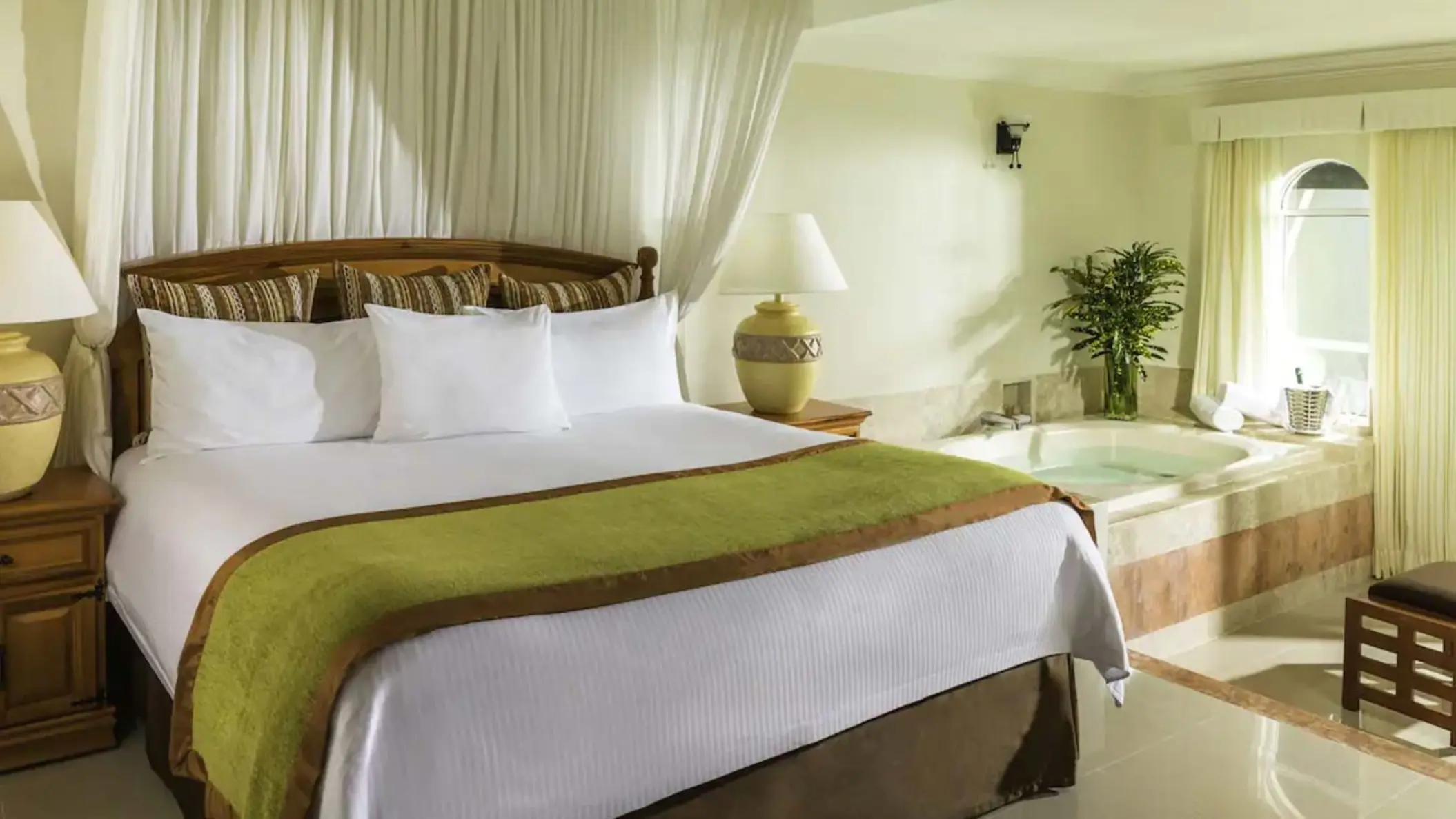 Suite with canopy bed and indoor hot tub at El Dorado Seaside Palms, Riviera Maya