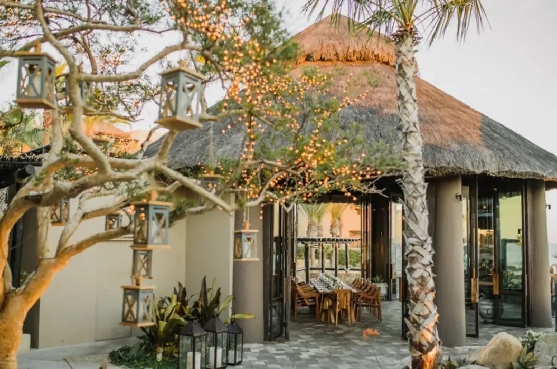 Palapa wedding reception with string lights and lanterns at Esperanza, Cabo San Lucas
