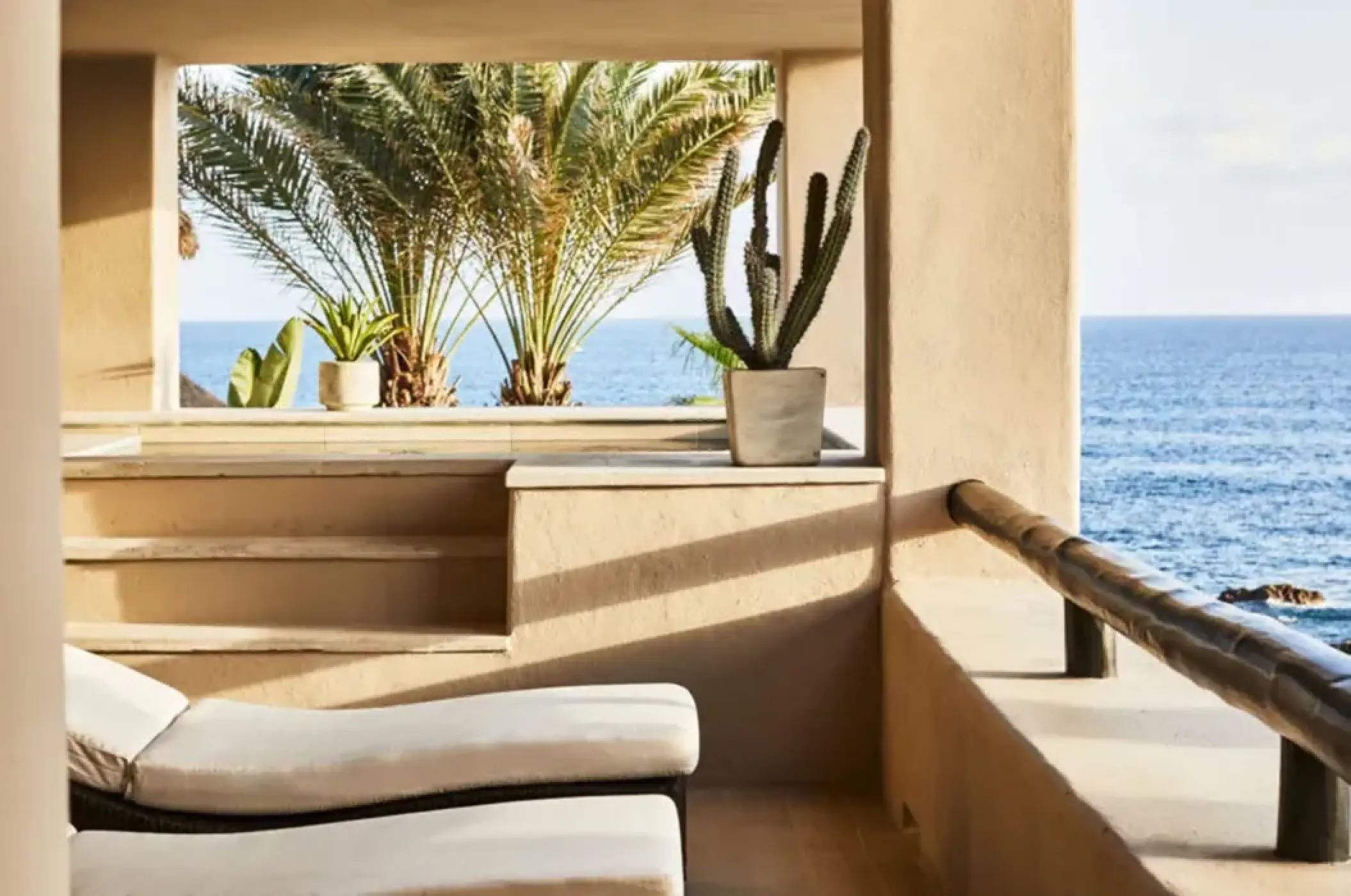 Private balcony with lounge chairs and ocean views at Esperanza Cabo San Lucas
