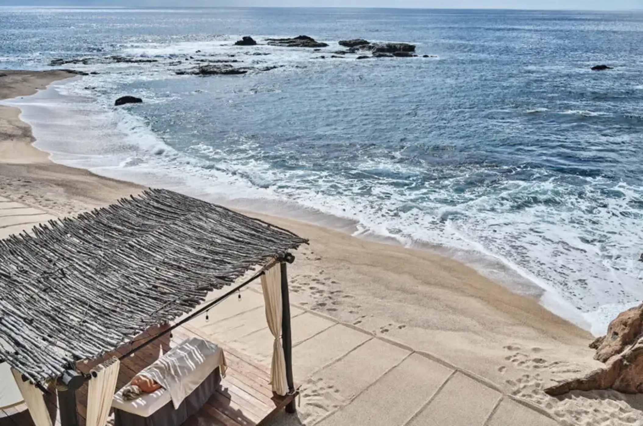 Beachfront spa massage under a thatched palapa at Esperanza Cabo San Lucas