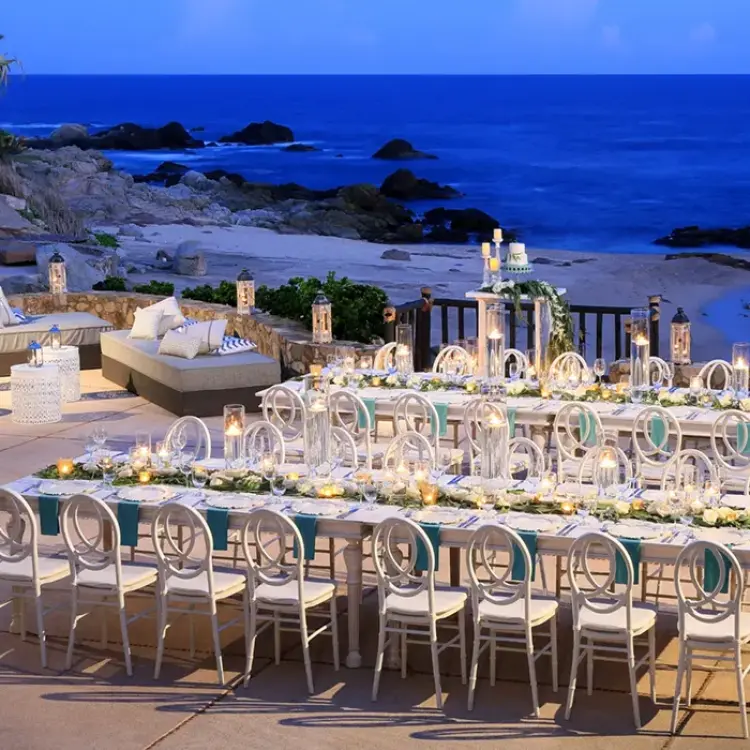 Terrace wedding reception with candlelit long tables at Esperanza, Cabo San Lucas