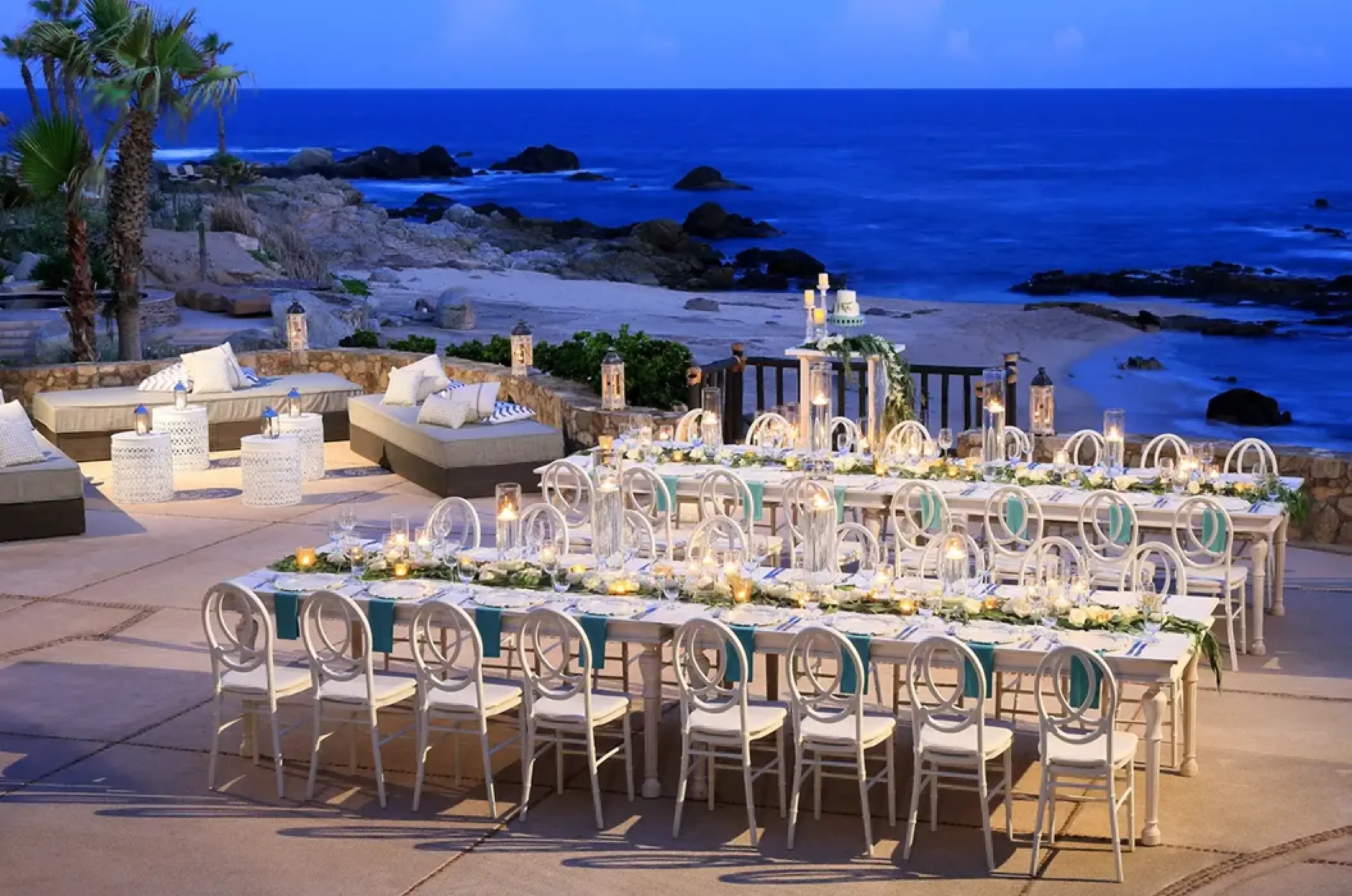 Terrace wedding reception with candlelit long tables at Esperanza, Cabo San Lucas