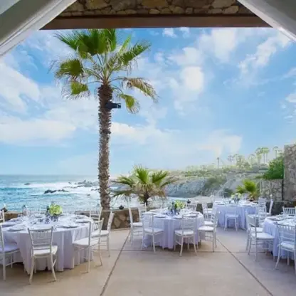 Terrace wedding reception with white table settings at Esperanza, Cabo San Lucas