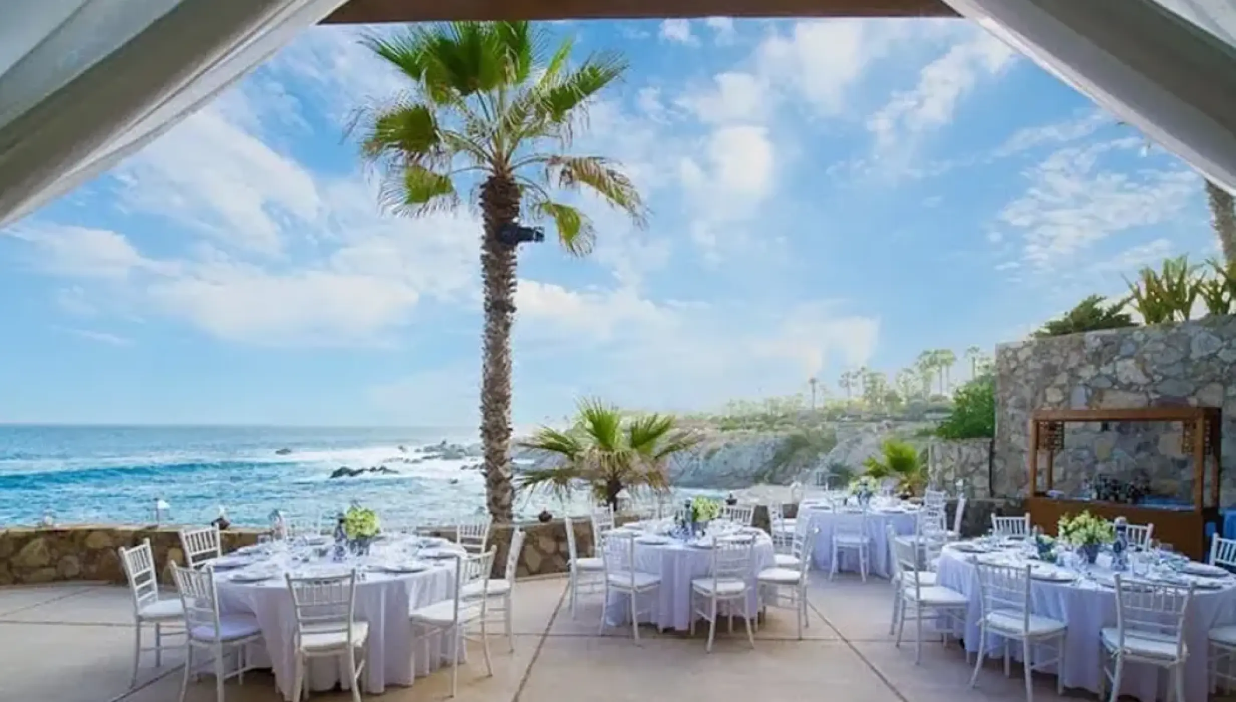Terrace wedding reception with white table settings at Esperanza, Cabo San Lucas
