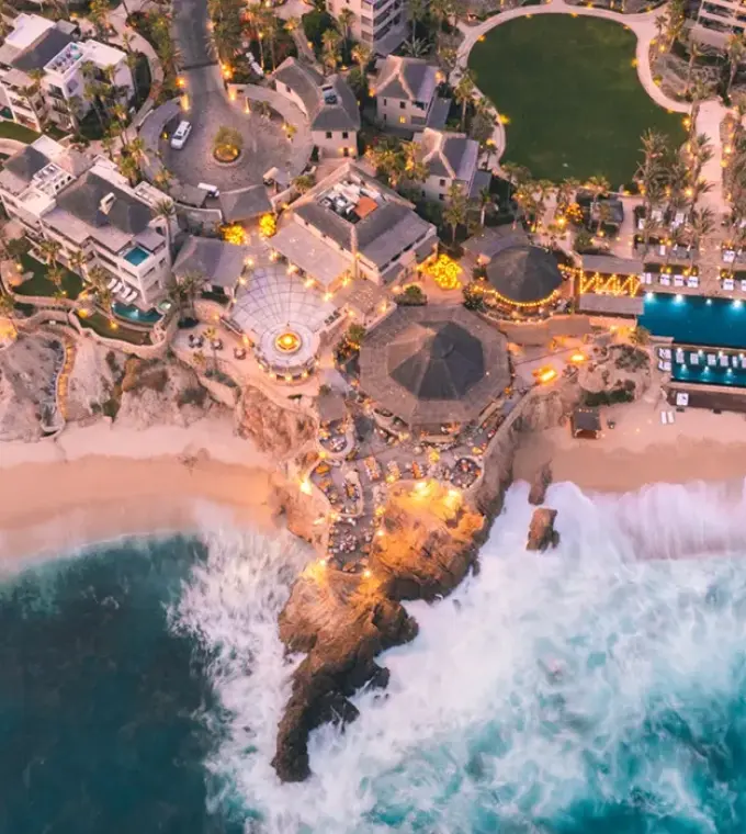 Overhead view of Esperanza Cabo San Lucas beachfront pools and cliffside buildings, Cabo San Lucas