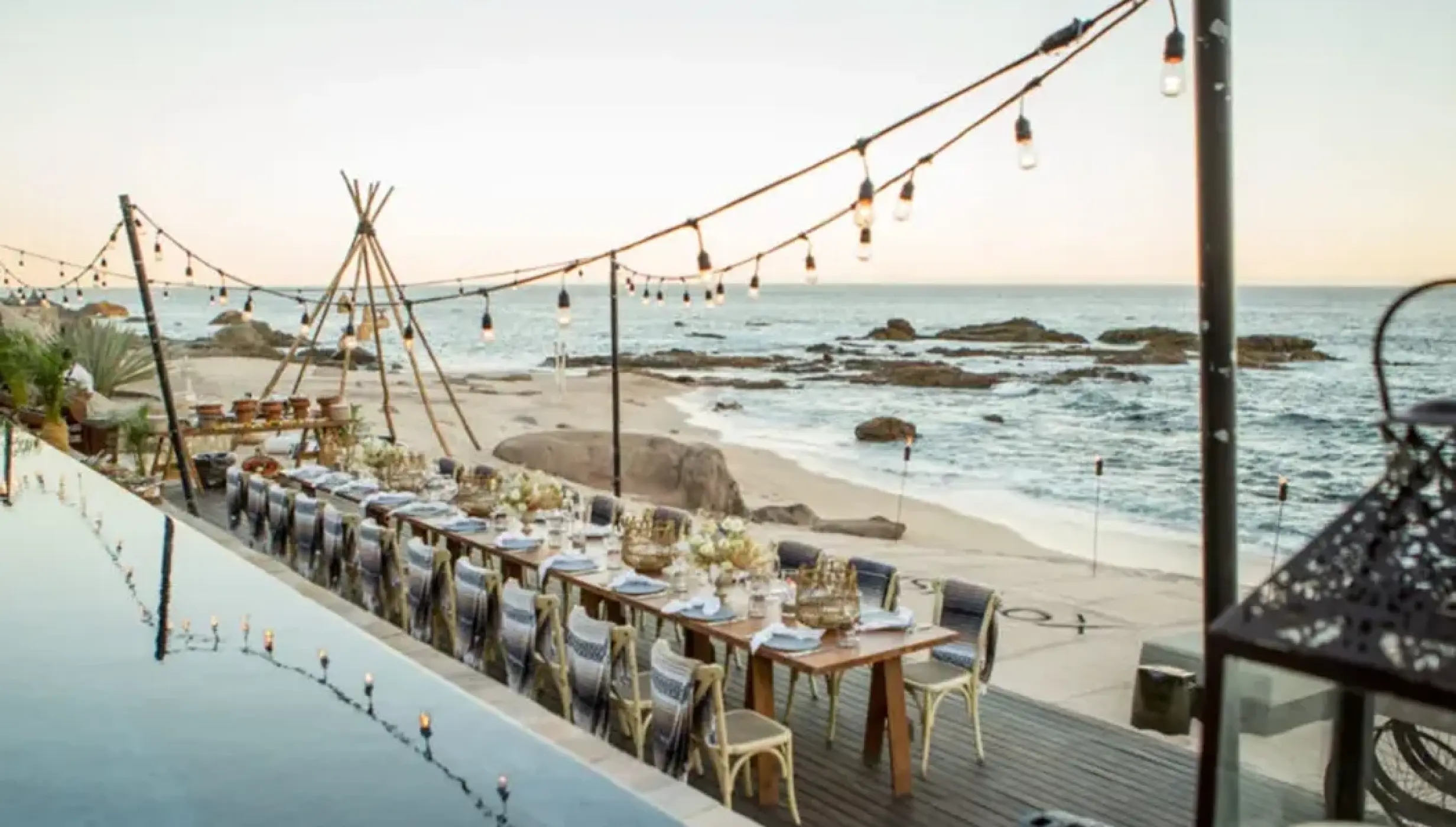 Beachfront wedding reception under string lights at Esperanza, Cabo San Lucas