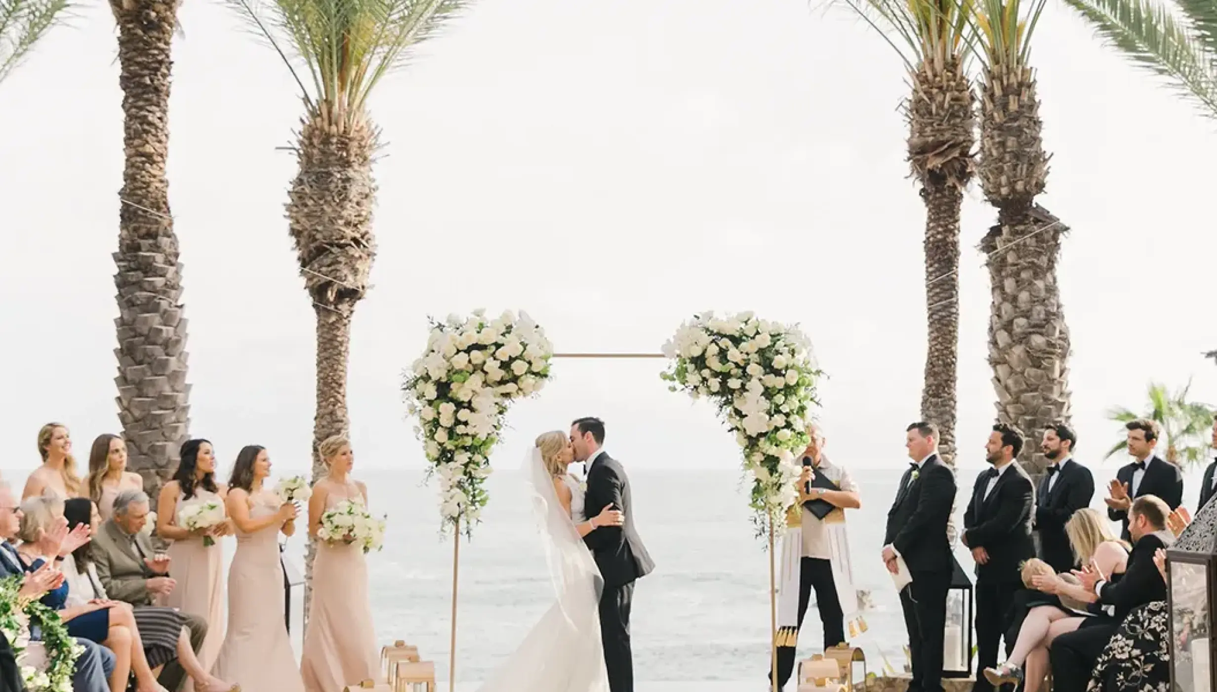 Couple kissing at a terrace wedding ceremony at Esperanza Cabo San Lucas