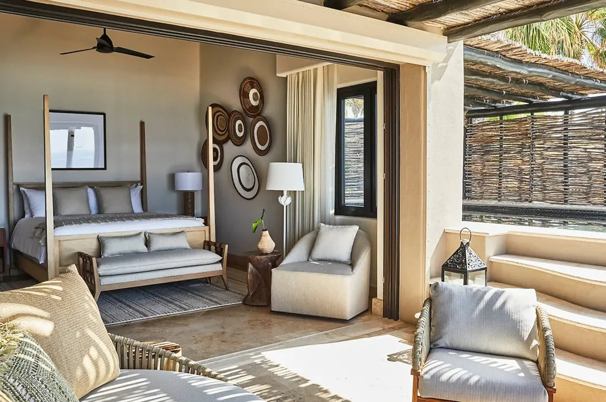 Esperanza Cabo San Lucas oceanfront villa bedroom with open wall leading to a private terrace