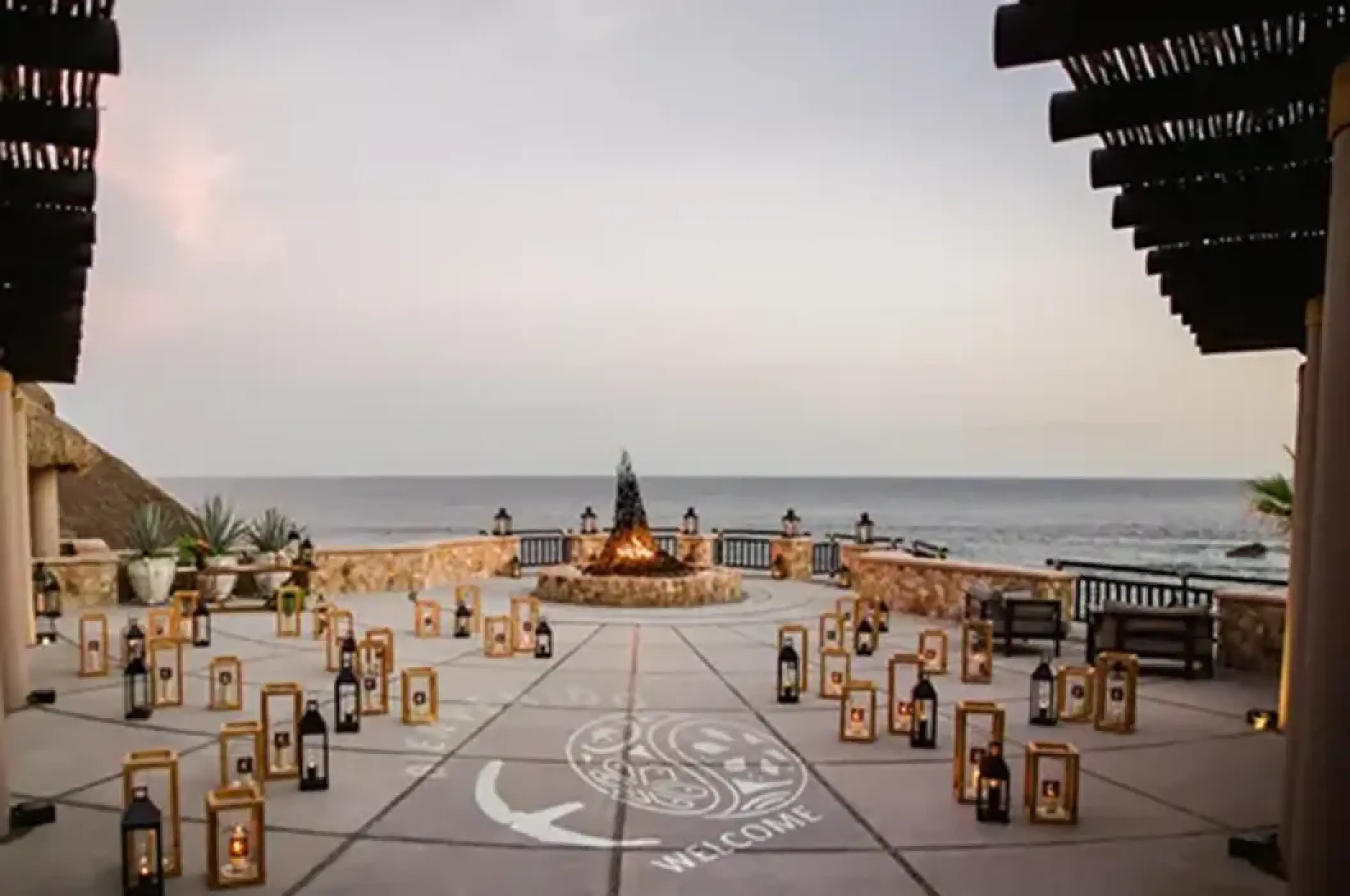 Terrace wedding reception setup with lanterns and fire pit at Esperanza, Cabo San Lucas