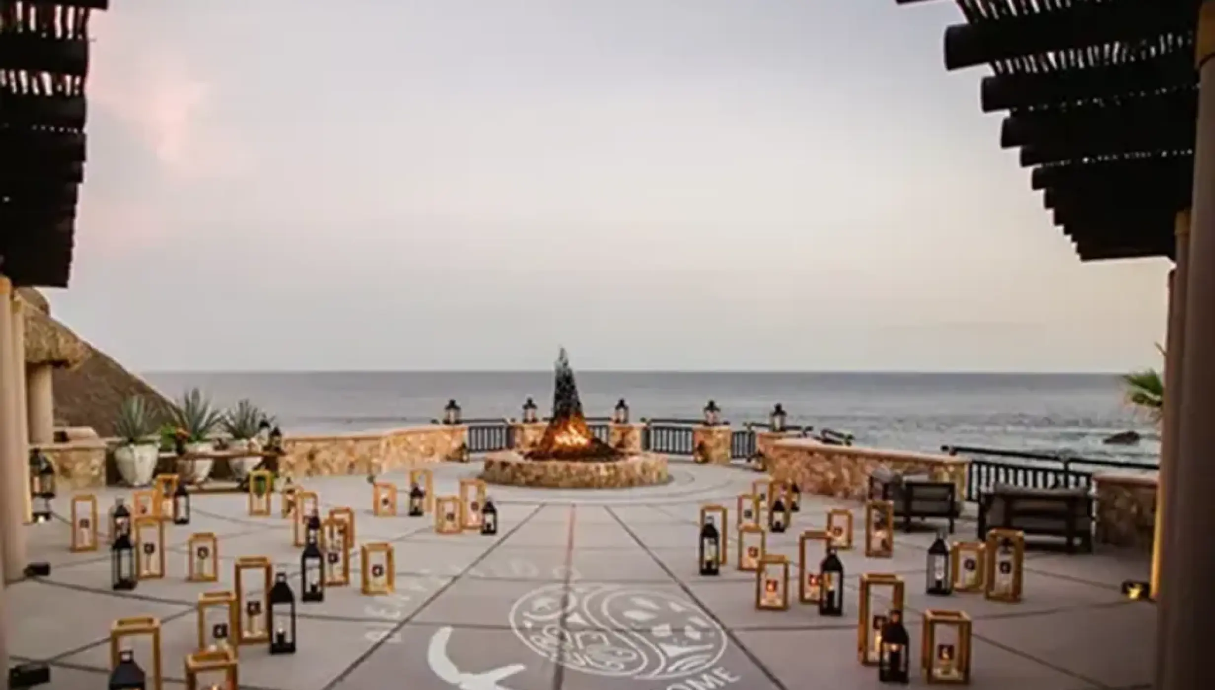 Terrace wedding reception setup with lanterns and fire pit at Esperanza, Cabo San Lucas