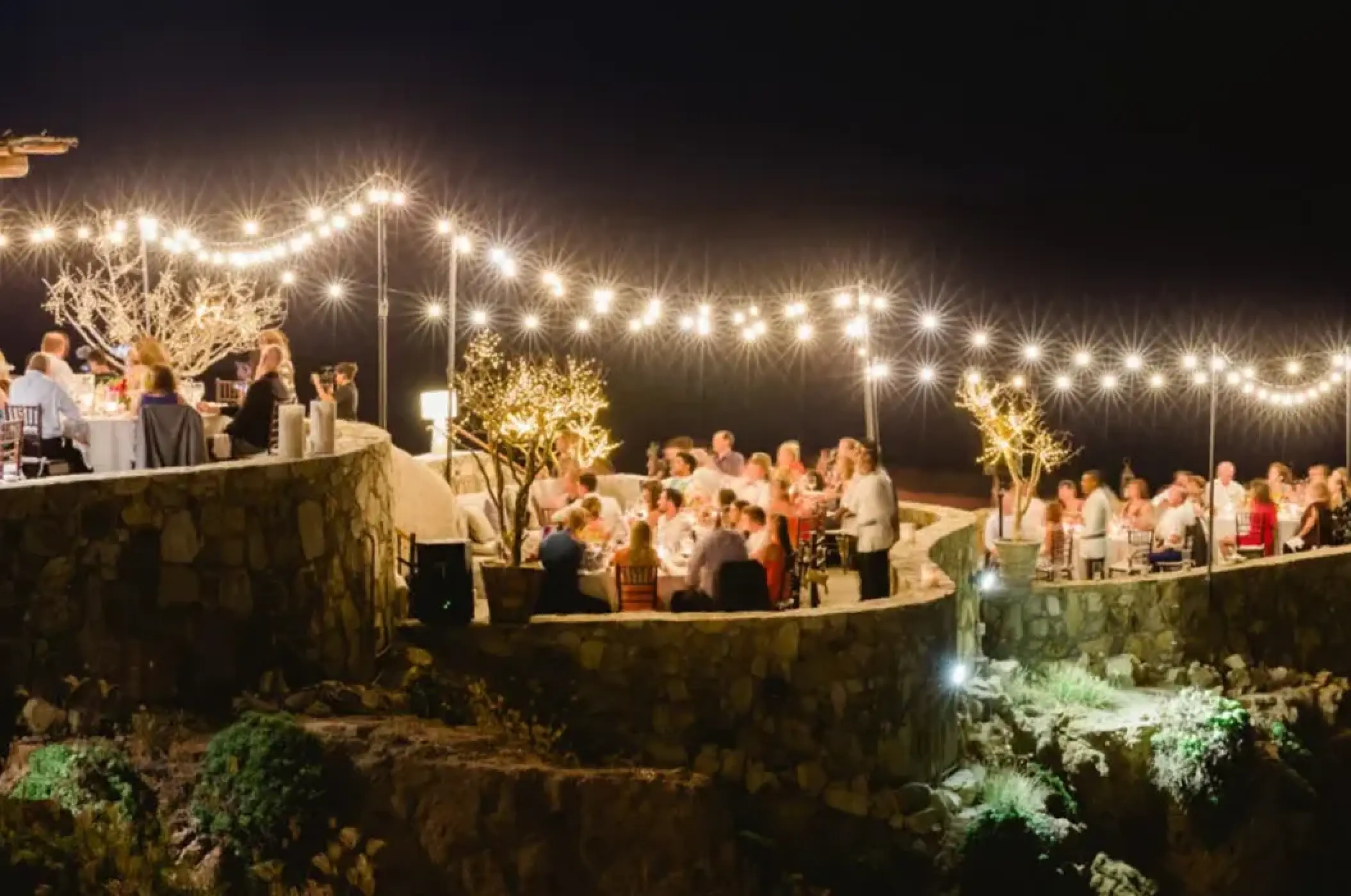 Evening wedding reception with string lights on the stone terrace at Esperanza, Cabo San Lucas