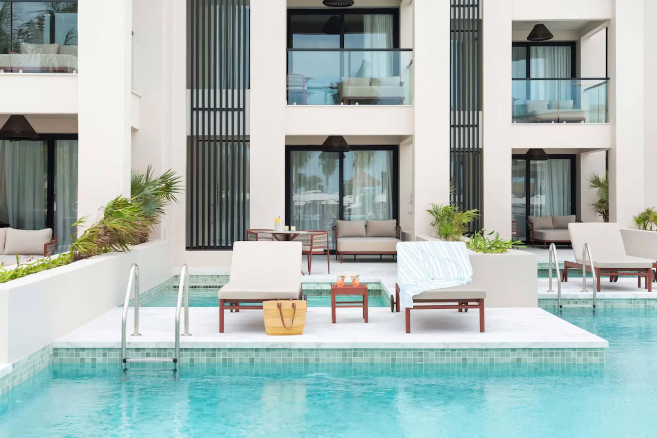 Swim-up suite exterior with sun loungers and pool access at Excellence Coral Playa Mujeres, Cancun