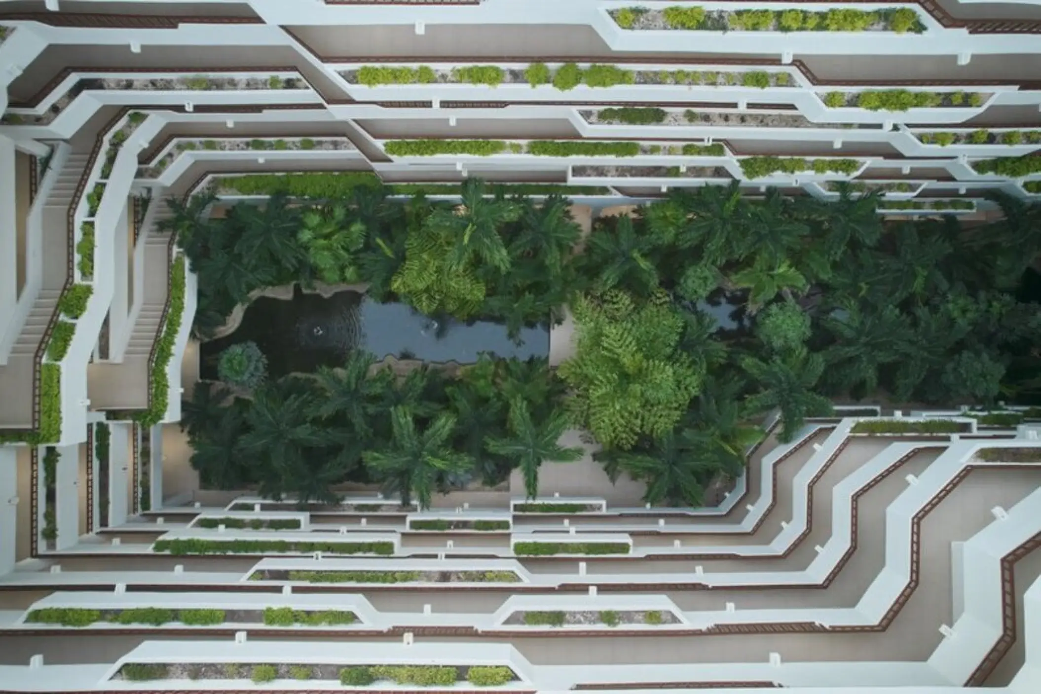 Overhead view of the lush garden atrium and palm trees at Fiesta Americana Condesa, Cancun
