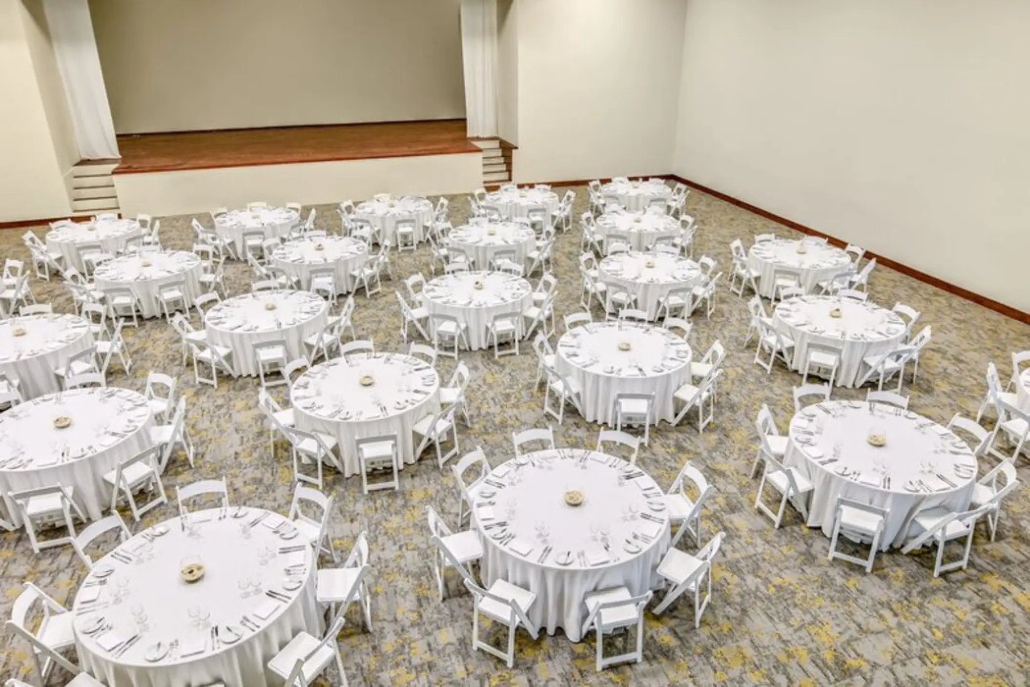 Indoor wedding reception with round tables and white linens at Fiesta Americana Condesa, Cancun