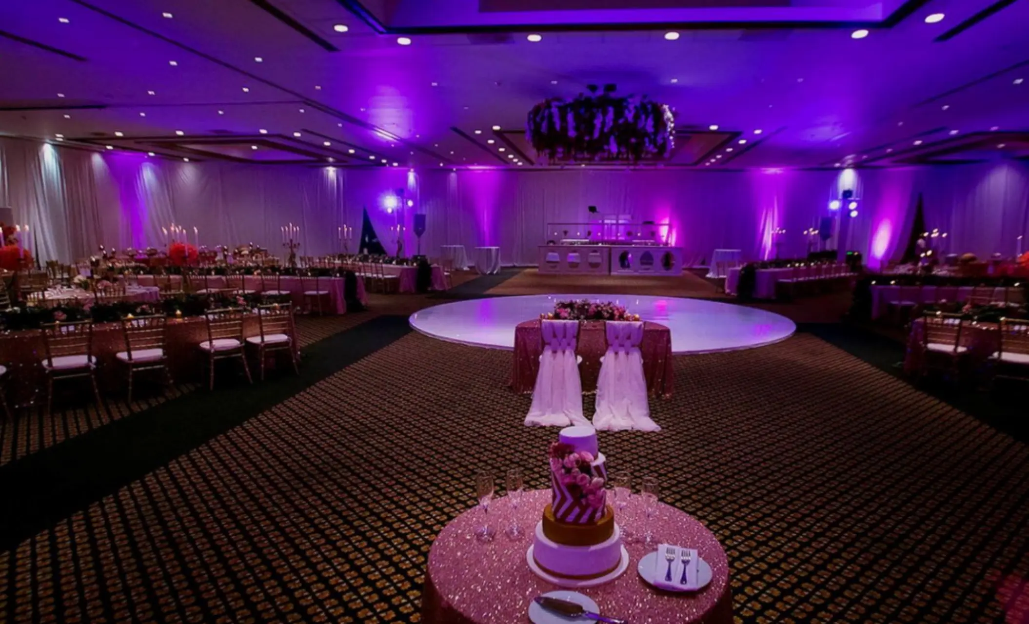 Ballroom wedding reception with purple lighting and a circular dance floor at Fiesta Americana Condesa, Cancun