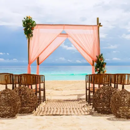 Beach wedding ceremony with pink draped huppah at Fiesta Americana Condesa, Cancun