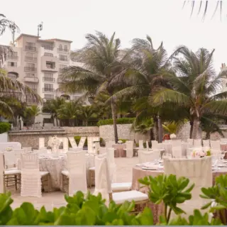 Outdoor wedding reception setup with light-up LOVE sign at Fiesta Americana Condesa, Cancun