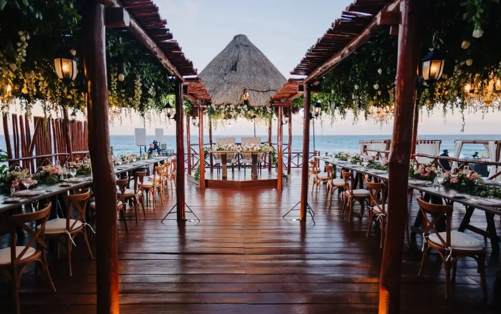 Wooden gazebo deck wedding reception with floral greenery at Fiesta Americana Condesa, Cancun