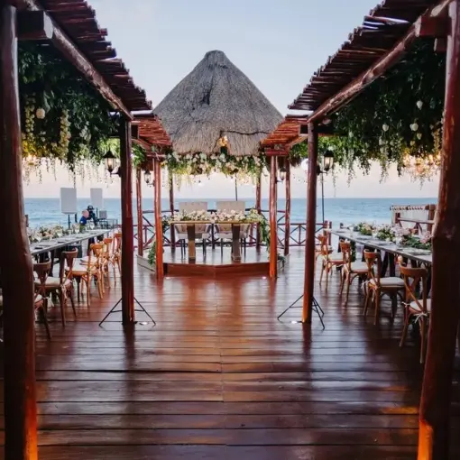 Wooden gazebo deck wedding reception with floral greenery at Fiesta Americana Condesa, Cancun