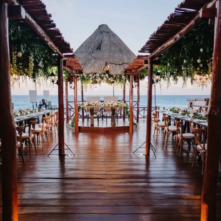 Wooden gazebo deck wedding reception with floral greenery at Fiesta Americana Condesa, Cancun