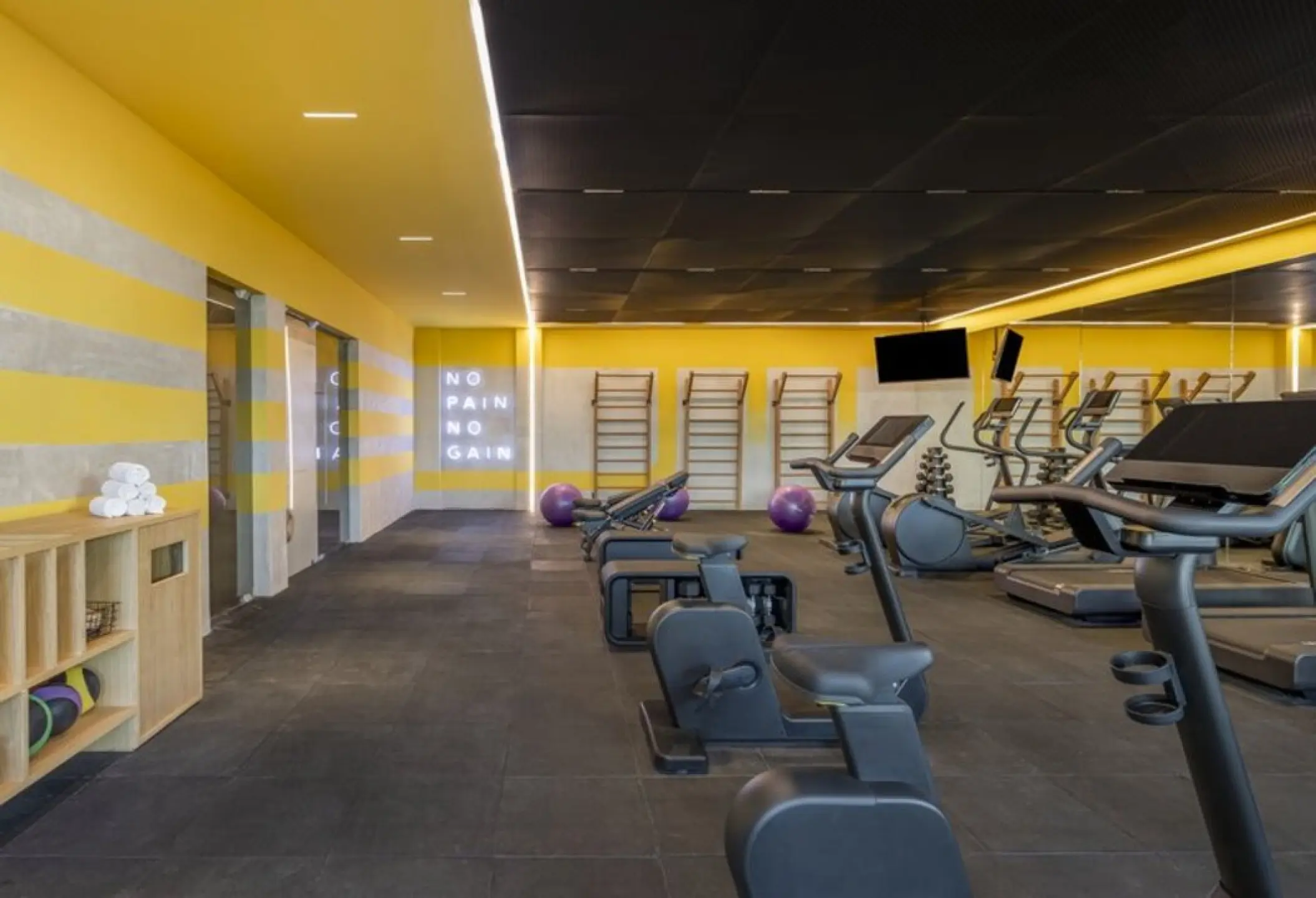 Modern gym with cardio machines and weight equipment at Fiesta Americana Condesa, Cancun