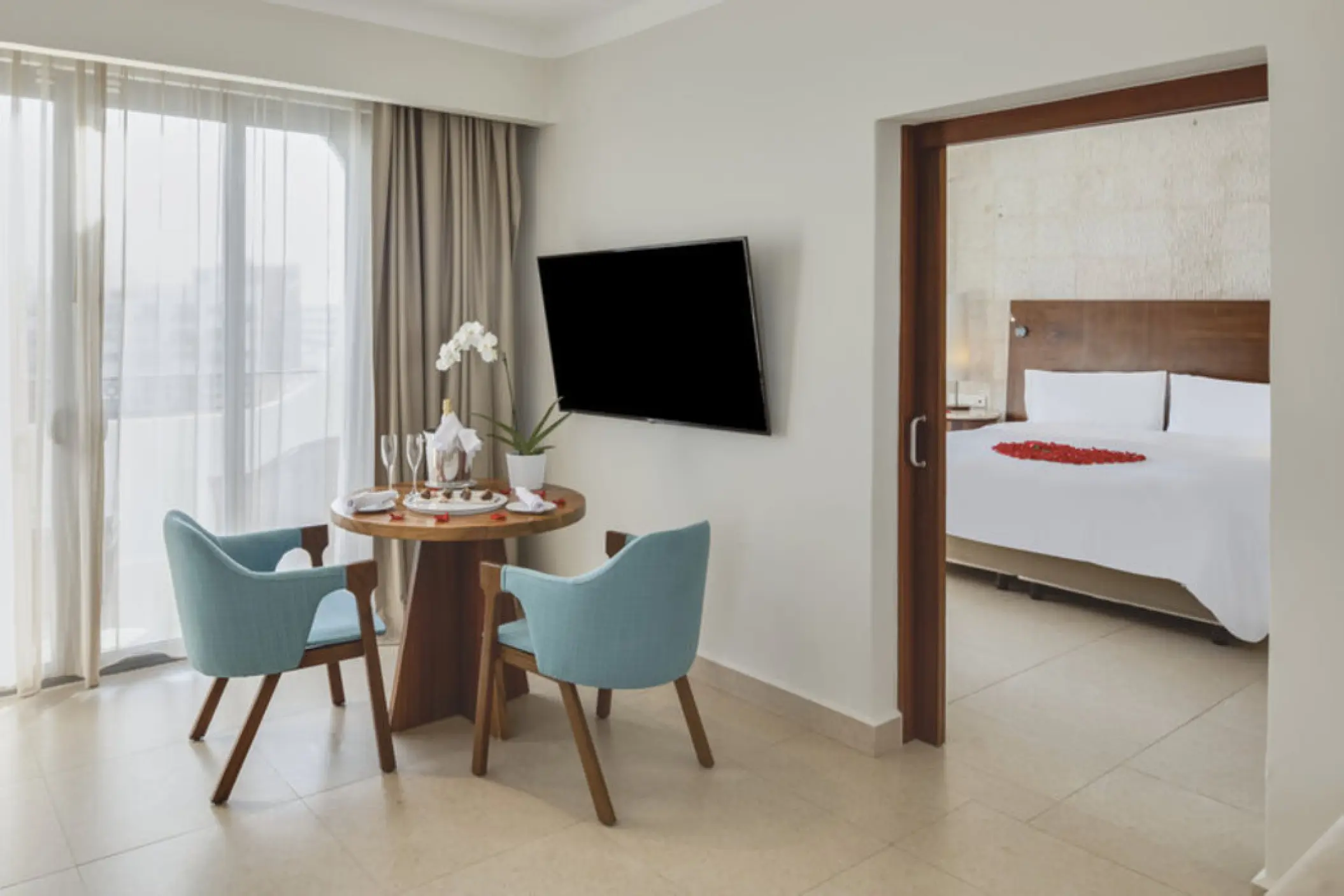 Honeymoon suite living area and bedroom with rose petals at Fiesta Americana Condesa, Cancun