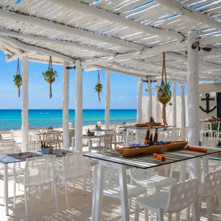 La Cevicheria beachfront restaurant with white wood pergola and ocean views at Fiesta Americana Condesa, Cancun