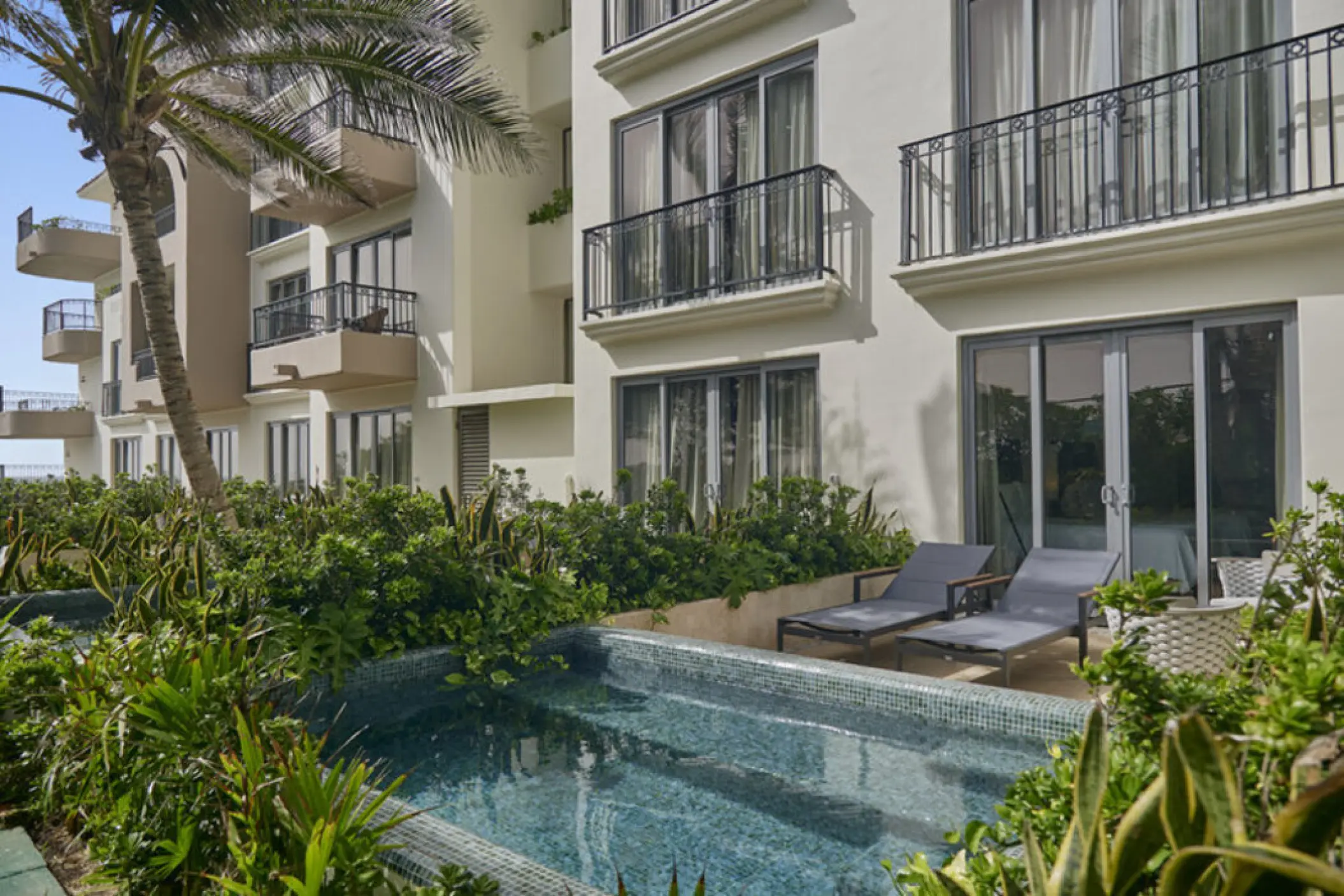 Fiesta Americana Condesa premium room exterior with a private plunge pool and lounge chairs, Cancun