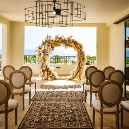 Presidential Suite terrace wedding ceremony with pampas grass arch at Fiesta Americana Condesa, Cancun